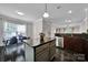 Kitchen island and eat-in dining area feature dark tile floors, bright light, open space and stainless appliances at 413 Hurston Cir, Charlotte, NC 28208