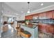 Kitchen with dark cabinetry, granite countertops, stainless appliances, tile backsplash, and a breakfast bar at 413 Hurston Cir, Charlotte, NC 28208