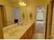 Bathroom with double sink vanity, tile floor, and a bright window view at 495 Bay Harbour Rd, Mooresville, NC 28117