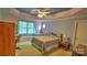 Cozy bedroom with decorative ceiling, carpeted floor, window bench, and charming decor at 495 Bay Harbour Rd, Mooresville, NC 28117