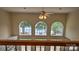 Bright foyer with arched windows featuring lake views, complemented by a ceiling fan and neutral tones at 495 Bay Harbour Rd, Mooresville, NC 28117