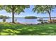 Picturesque waterfront lawn, featuring a sandy beach and dock access to the calm lake at 495 Bay Harbour Rd, Mooresville, NC 28117