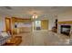 Open living space with kitchenette, stone fireplace, and wood-look flooring at 495 Bay Harbour Rd, Mooresville, NC 28117