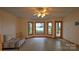 Bright living room boasts a ceiling fan and scenic water views from the large bay windows at 495 Bay Harbour Rd, Mooresville, NC 28117
