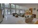 Bright living room with floor-to-ceiling windows offering stunning waterfront views and a cozy fireplace at 495 Bay Harbour Rd, Mooresville, NC 28117