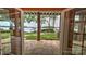 Step onto the stone patio and enjoy stunning lake views framed by brick columns and lush landscaping at 495 Bay Harbour Rd, Mooresville, NC 28117