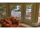 Cozy sitting room with a comfortable armchair, featuring serene lake views from bay windows at 495 Bay Harbour Rd, Mooresville, NC 28117