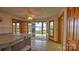 Sun room with jacuzzi and water views from the surrounding bay windows and door to outside patio at 495 Bay Harbour Rd, Mooresville, NC 28117