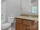 Half bathroom featuring tile floors, vanity and standard toilet at 5076 Newport Lakes Dr, Rock Hill, SC 29732