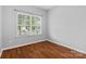 Bedroom features a large window with horizontal blinds and hardwood floors at 5076 Newport Lakes Dr, Rock Hill, SC 29732