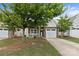 Inviting brick and vinyl home with a tidy front yard and a garage at 5076 Newport Lakes Dr, Rock Hill, SC 29732