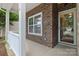 Charming front entrance with brick facade, front door and white railings at 5076 Newport Lakes Dr, Rock Hill, SC 29732