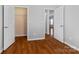Hallway with view of two open doors leading to rooms and hardwood floors at 5076 Newport Lakes Dr, Rock Hill, SC 29732