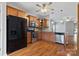 Kitchen with stainless appliances, wooden cabinets, granite countertops, and a black refrigerator at 5076 Newport Lakes Dr, Rock Hill, SC 29732
