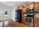 Kitchen featuring stainless steel appliances, wooden cabinetry, and a door to the exterior at 5076 Newport Lakes Dr, Rock Hill, SC 29732