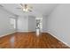 Spacious living room with hardwood floors, ceiling fan, and a view of the front entry at 5076 Newport Lakes Dr, Rock Hill, SC 29732