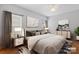 Tastefully decorated main bedroom featuring elegant furnishings, neutral colors, and natural light from the window at 5076 Newport Lakes Dr, Rock Hill, SC 29732