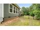 Home's exterior showcasing the backyard with a black metal fence and green grass at 508 Flour Mill Ct, Fort Mill, SC 29715