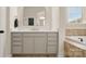 Bright bathroom features a marble countertop vanity with gold fixtures and a large mirror at 508 Flour Mill Ct, Fort Mill, SC 29715