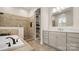 Luxurious bathroom features a soaking tub, tiled shower, built-in shelving, and a marble countertop vanity at 508 Flour Mill Ct, Fort Mill, SC 29715