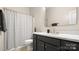 Bathroom featuring a marble countertop vanity with gold fixtures and a tiled shower with curtain at 508 Flour Mill Ct, Fort Mill, SC 29715