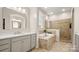 Luxurious bathroom featuring a soaking tub, walk-in shower, and double vanity with elegant gold fixtures at 508 Flour Mill Ct, Fort Mill, SC 29715