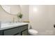 Half bath with a marble countertop vanity with gold fixtures at 508 Flour Mill Ct, Fort Mill, SC 29715