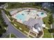 Aerial view of neighborhood aquatic center featuring a pool, splashpad, clubhouse, and ample parking at 508 Flour Mill Ct, Fort Mill, SC 29715