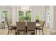 Bright dining room with a large window, stylish chandelier, and elegant table setting, ideal for gatherings at 508 Flour Mill Ct, Fort Mill, SC 29715