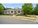 Beautiful one-story home with a charming front porch, a vibrant green lawn, and mature trees at 508 Flour Mill Ct, Fort Mill, SC 29715