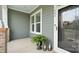 Charming front porch featuring a decorative wreath on the door, potted plants, and lantern accents at 508 Flour Mill Ct, Fort Mill, SC 29715