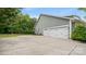 Side angle of home showing a large driveway leading to an attached two car garage with white doors at 508 Flour Mill Ct, Fort Mill, SC 29715