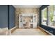 Bright home office featuring custom built-ins, a decorative wallpaper, and hardwood floors at 508 Flour Mill Ct, Fort Mill, SC 29715