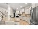 Spacious kitchen featuring a granite island, stainless steel appliances, and modern lighting fixtures at 508 Flour Mill Ct, Fort Mill, SC 29715