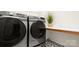 Efficient laundry room showcasing modern washer and dryer set with countertop space, perfect for simplifying chores at 508 Flour Mill Ct, Fort Mill, SC 29715