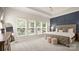 Spacious main bedroom with a decorative accent wall, plush carpeting, and ample natural light from multiple windows at 508 Flour Mill Ct, Fort Mill, SC 29715