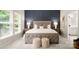 Elegant main bedroom with a blue accent wall, carpet, and a tufted headboard for a serene retreat at 508 Flour Mill Ct, Fort Mill, SC 29715