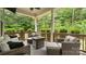 Cozy covered patio with wicker furniture and wooded view, perfect for relaxing outdoors at 508 Flour Mill Ct, Fort Mill, SC 29715