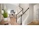 Elegant staircase with carpeted steps, white railings, and a view into the open-concept living space at 508 Flour Mill Ct, Fort Mill, SC 29715