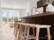Kitchen island with seating and modern finishes overlooking the light-filled living room at 5512 Swaling St, Charlotte, NC 28217