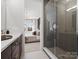 Modern bathroom featuring glass-enclosed shower and bedroom view with natural light at 5517 Swaling St, Charlotte, NC 28217