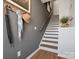 Welcoming hallway with coat rack, stylish decor, and staircase leading upstairs at 5517 Swaling St, Charlotte, NC 28217