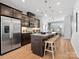 Modern kitchen with dark cabinetry, stainless steel appliances, and large island with seating at 5517 Swaling St, Charlotte, NC 28217