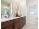 Well-lit bathroom featuring a double vanity, dark wood cabinets, and modern fixtures at 5524 Swaling St, Charlotte, NC 28217