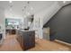 Modern kitchen with an island, pendant lighting, hardwood floors and stainless steel appliances at 5735 Castlerea Dr, Charlotte, NC 28217