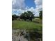 Wide-angle shot of sprawling backyard, complete with shade trees and a scenic lake at 6006 White Store Rd, Marshville, NC 28103
