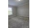 A bedroom showcasing neutral walls, carpet and a sunny window at 6006 White Store Rd, Marshville, NC 28103