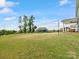 Large backyard featuring lush green lawn, volleyball net, and covered patio for outdoor fun at 6012 Millbridge Pkwy, Waxhaw, NC 28173