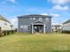 Back of house featuring a covered patio, large windows, and a well-maintained lawn at 6012 Millbridge Pkwy, Waxhaw, NC 28173