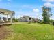 Expansive backyard with well-maintained lawn and covered patio ideal for outdoor gatherings and relaxation at 6012 Millbridge Pkwy, Waxhaw, NC 28173